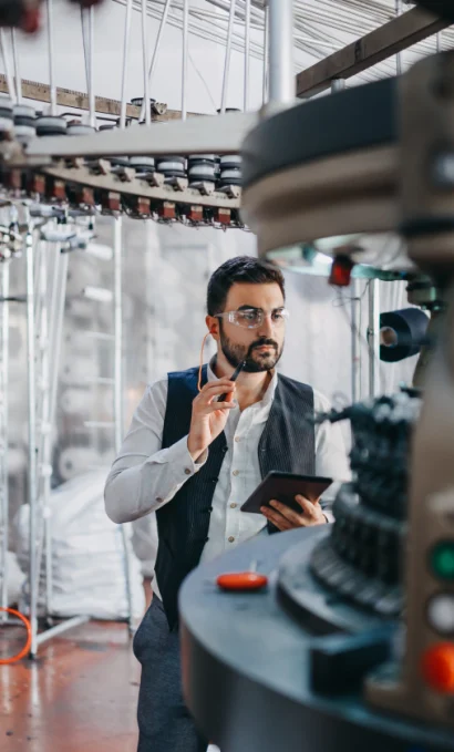Production manager at a knitting machine